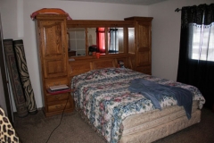 A bedroom with two beds and a dresser