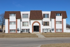 A large white building with red trim on the front.