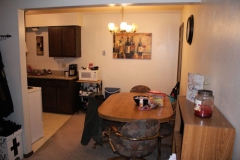 A kitchen with a table and chairs in it
