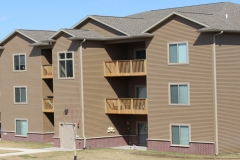 A brown building with balconies and windows.