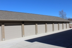 A row of garage doors on the side of a building.