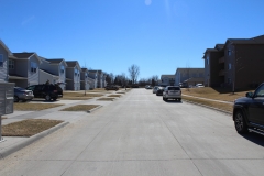 A street with cars parked on the side of it.