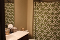 A bathroom with a sink, mirror and toilet.