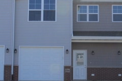 A house with two windows and a door.