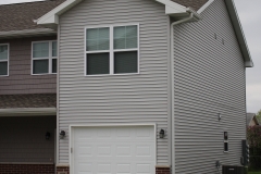 A house with two garage doors and windows.