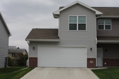 A house with two garage doors and a driveway.