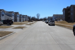 A street with cars parked on the side of it.