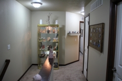 A room with a shelf and a door way